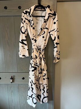 chic Black and Cream Abstract Midi Wrap Dress